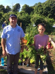 Russ Norton and MG Children’s Gardener, Isabel Colella, at Brewster Conservation Trust community garden, 7/31/18